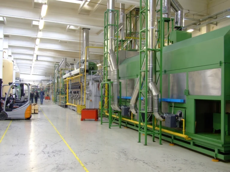 Food-processing plant with a production line of green machinery running the length of the factory floor